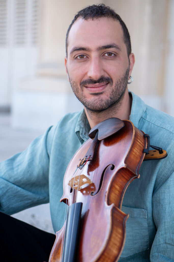 A photo of Karam AlZouhir playing the alto instrument for Jeune Mort performance